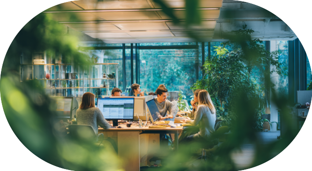 Employees collaborating in a natural green office environment.