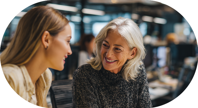 Two women discussing career opportunities with a smile.
