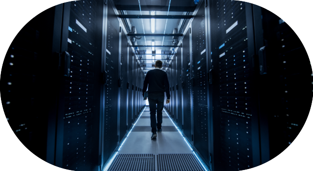 Technicien marchant dans un datacenter gestion et surveillance d’infrastructures IT stratégiques